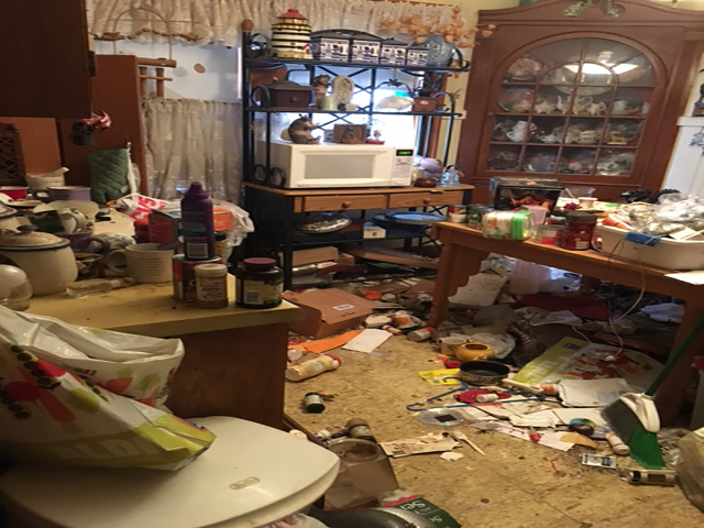 Kitchen buried in clutter before our crew arrived