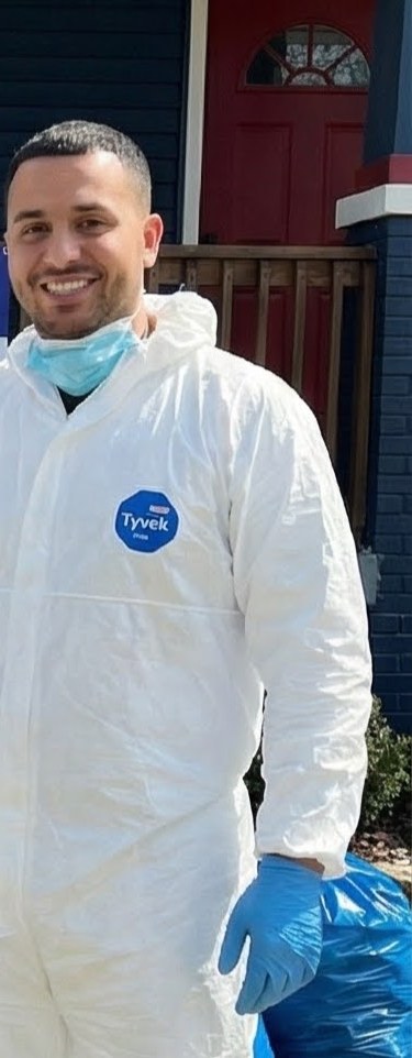 Technician in protective coveralls and gloves